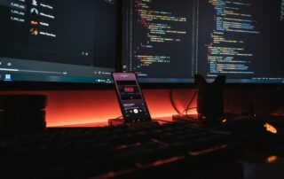 Developer coding on 3 screens for ui / ux development project